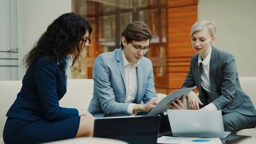 Financial advisors reviewing figures on a laptop